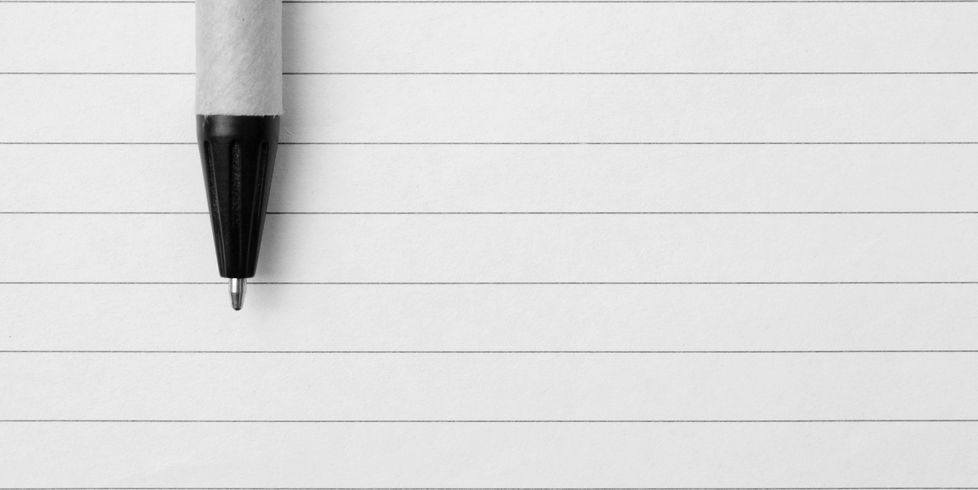 a pen resting on lined paper