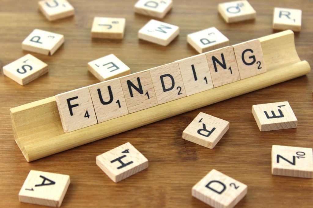 Scrabble tiles spelling out funding