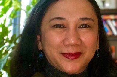 a woman with dark hair smiling