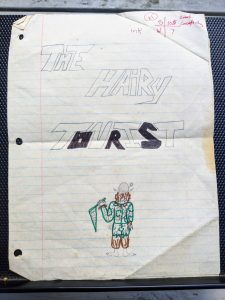 a child's drawing of a being in a helmet with 'The Hairy Tourist' written on it