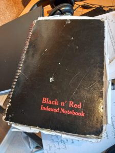 a black notebook cover, it looks well loved 
