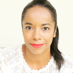 a closeup of a woman's face looking and smiling slightly at the camera