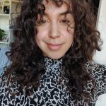 a photo of a woman with long curly hair 