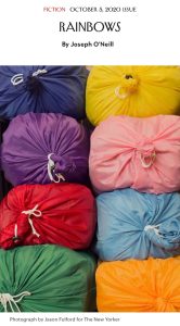 Colorful bundles wrapped in fabric are stacked in a grid pattern. Each bundle is a different color, including blue, yellow, purple, pink, red, and green.